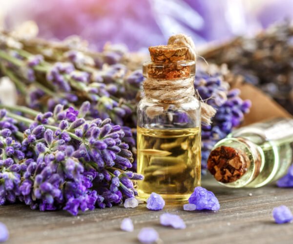 lavender's spa products with dried lavender flowers on a wooden table. Flat lay bath salt and massage oil on wooden background. Skin care, beauty treatment concept. Lavendula oleum